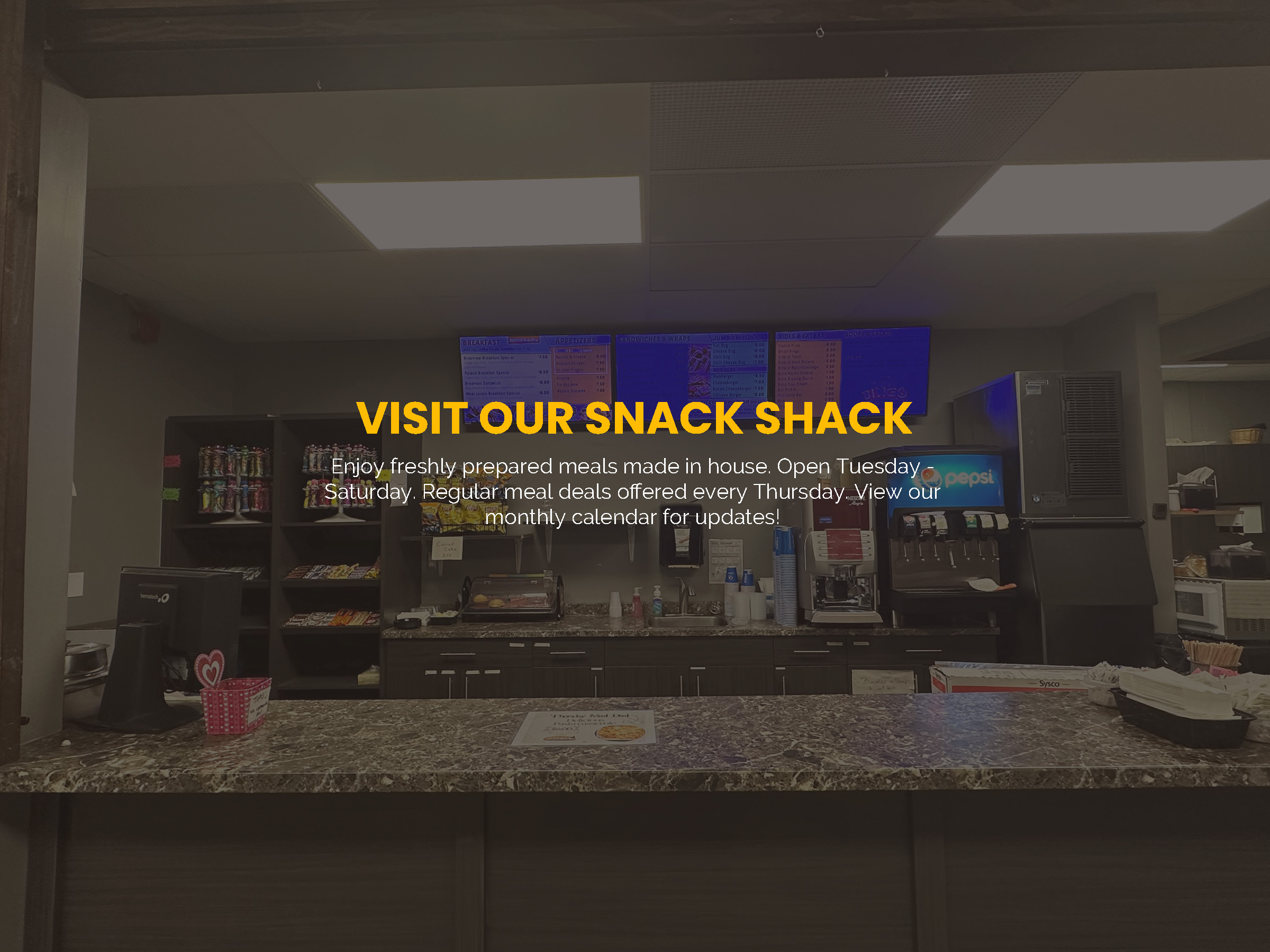 Picture of our Snack Shack with a caption reading "Visit our snack shack. Enjoy freshly prepared meals made in house. Open Tuesday - Saturday. Regular meal deals offered every Thursday. View our monthly calendar for updates!"